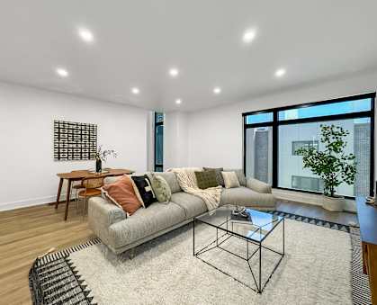 a living room with a couch and a glass coffee table at Matilda 235 Townhomes, Des Moines