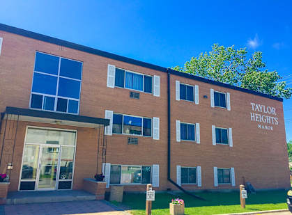 The front of a building named Taylor for Heights Manor.