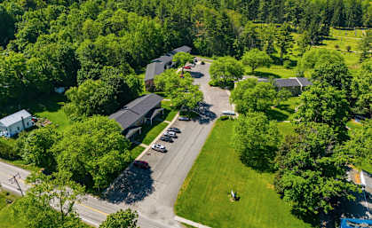 A bird's eye view of a residential area surrounded by trees.