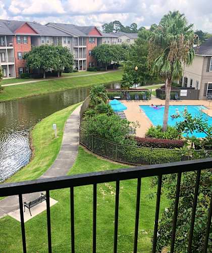 A view of a pool and fountain from a balcony.
