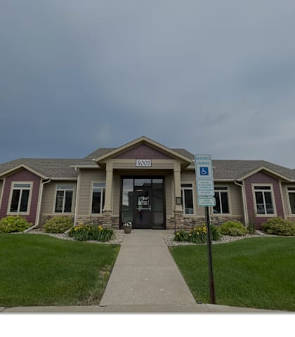 The image shows a building with a sign in front of it.