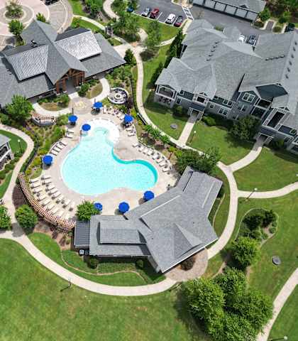 an aerial view of a large swimming pool in a neighborhood with houses at The Crest at Laurel Canyon, Canton