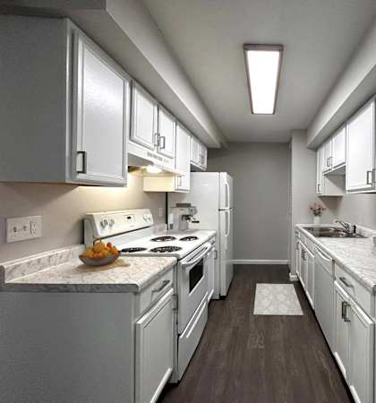 A kitchen with white appliances and cabinets.
