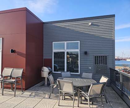 A patio with a table and chairs is on a balcony.