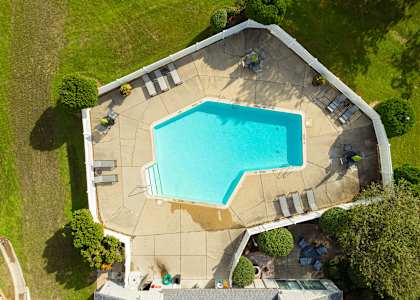 arial view of a swimming pool in the backyard of a house