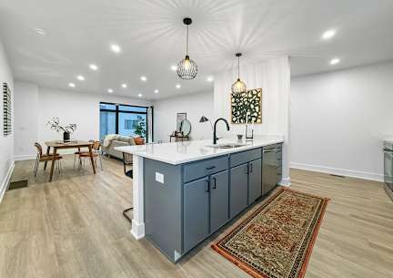 A kitchen with a large island and a dining table. at Matilda 235 Townhomes, Des Moines, 50309