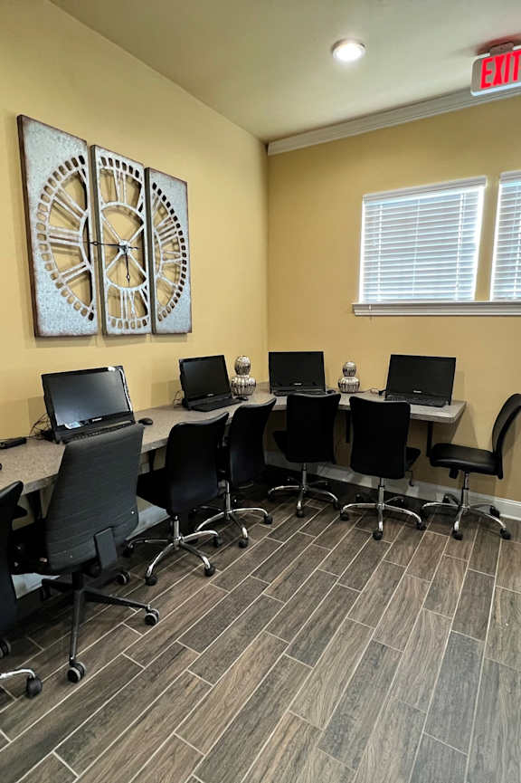 A reception area with a piano and chairs.
