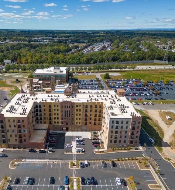 an aerial view of a building in a parking lot