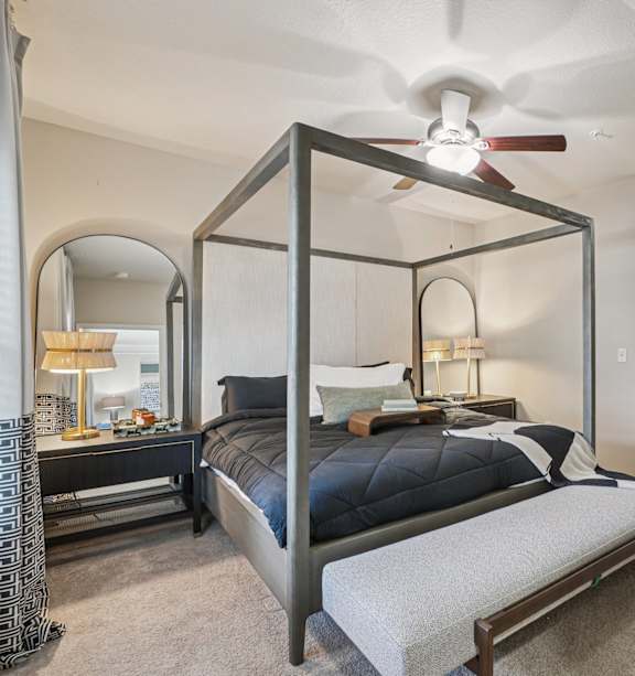 a bedroom with a bed and a ceiling fan