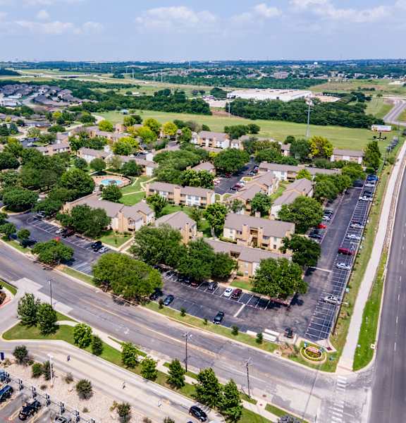 an aerial view of a neighborhood with cars parked on the street and trees at Summit Ridge Apartments, Temple, TX, 76502