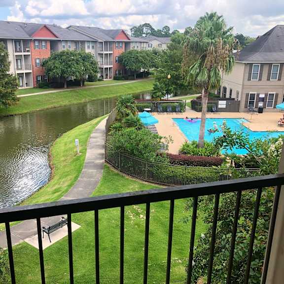 A view of a pool and fountain from a balcony.