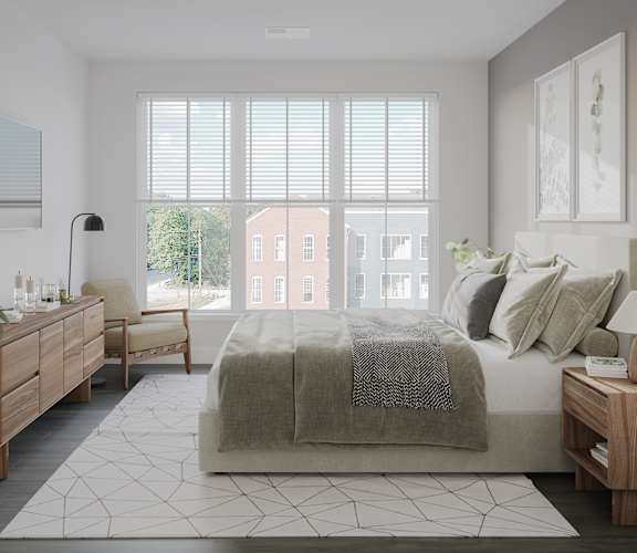 a bedroom with a bed and a large window