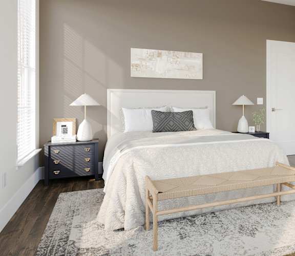 a bedroom with a white bed and a rug