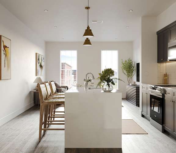 a kitchen and living room with a white island and a dining room table