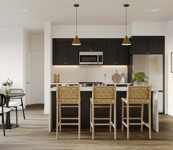 a kitchen with an island with stools in a modern apartment