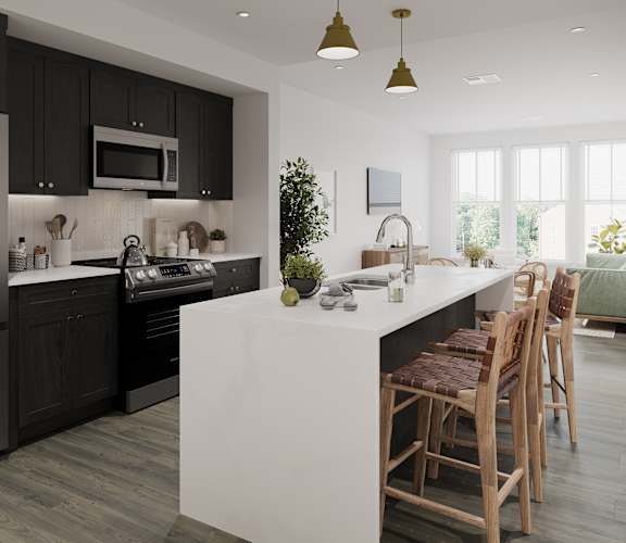 a kitchen with black cabinets and a white island with chairs
