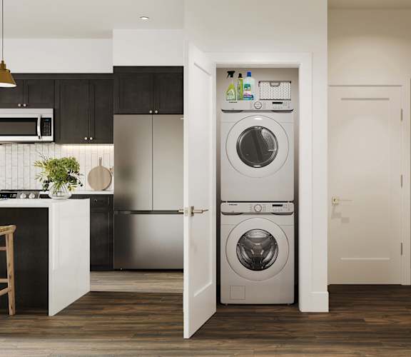 a white front loading washer and dryer in a kitchen