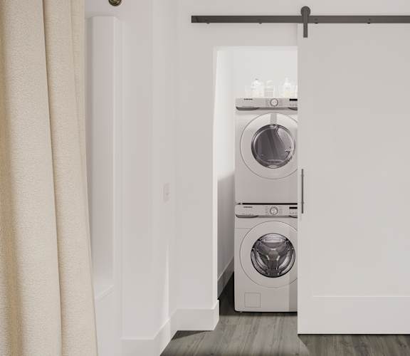 a white washer and dryer in a white closet