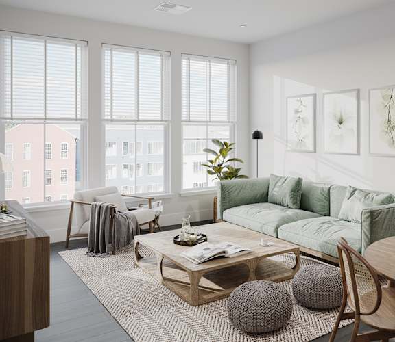 a living room with a green couch and a coffee table