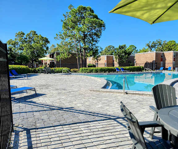 swimming pool area with pool table and lounge chairs, Timberfalls Apartments