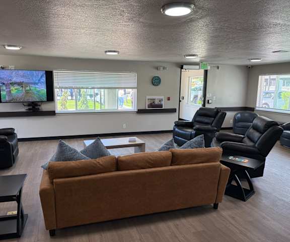 A living room with a brown couch and a television.
