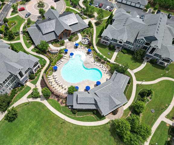 an aerial view of a large swimming pool in a neighborhood with houses at The Crest at Laurel Canyon, Canton