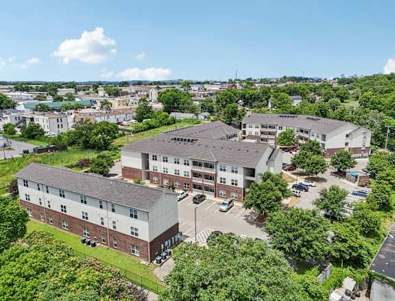 A large building complex with a parking lot in front.