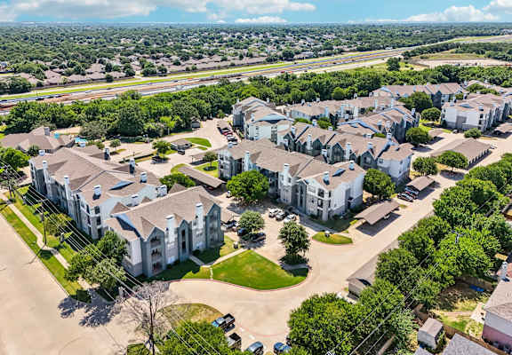 an aerial view of a neighborhood with houses and trees