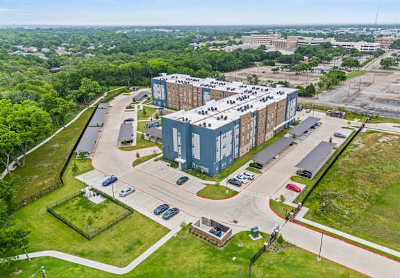 A large building with a parking lot in front of it.
