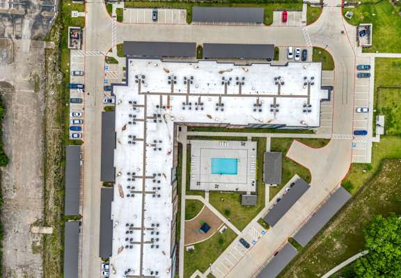 A large building with a pool in the middle of it.