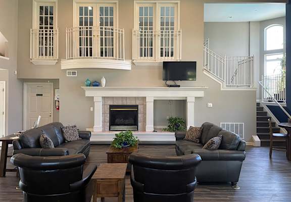 A living room with a fireplace and a television.
