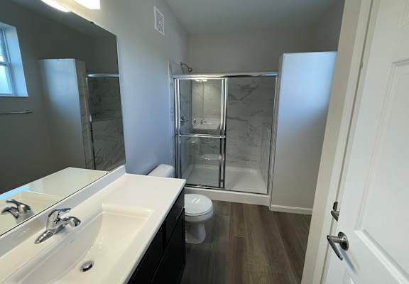 A bathroom with a white sink and a walk-in shower at Hamlet On The Bend, Hebrun, KY, 41048