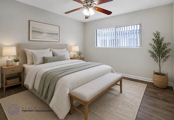 A bedroom with a bed, a bench, a ceiling fan, and a potted plant.
