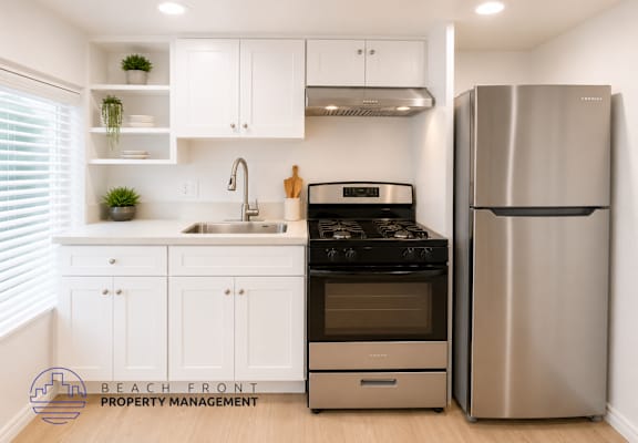 A modern kitchen with a stainless steel refrigerator and stove.