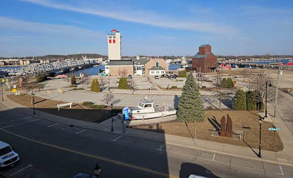 A view of a parking lot with a white car and a white van.