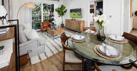 A dining room with a glass table and chairs.