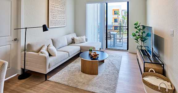 A living room with a white couch and a coffee table.