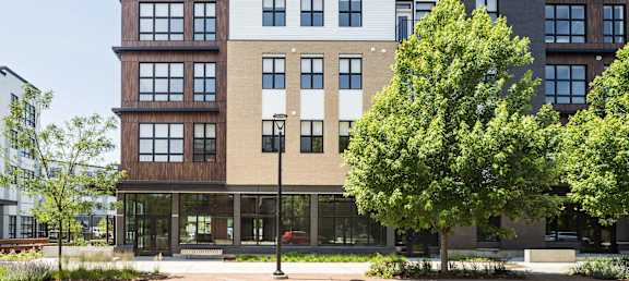 A modern building with a mix of wood and brick exterior.