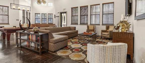 a living room with couches and chairs and a rug