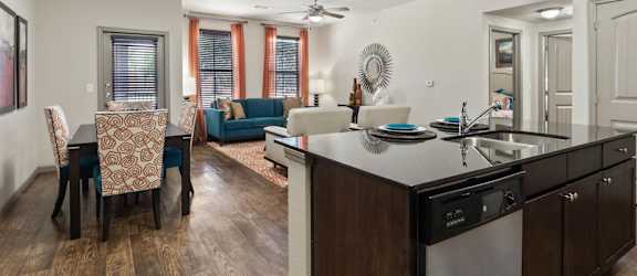 a living room with a kitchen and a dining room
