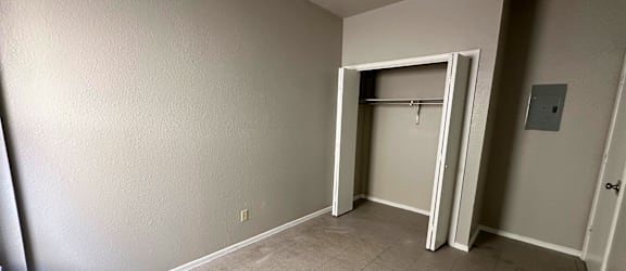 A room with a white door and a tiled floor.