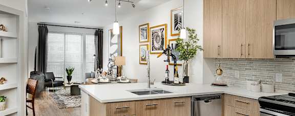 A modern kitchen with wooden cabinets and stainless steel appliances.