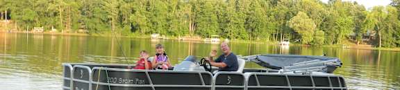 a group of people on a pontoon boat on a lake