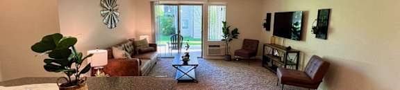 a living room with couches and chairs and a counter top at Mullan Reserve Apartments, Missoula, Montana