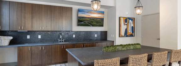 A modern dining room with a large painting on the wall and a wooden table surrounded by chairs.