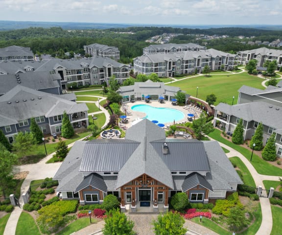 an aerial view of a large complex with a swimming pool and golf course