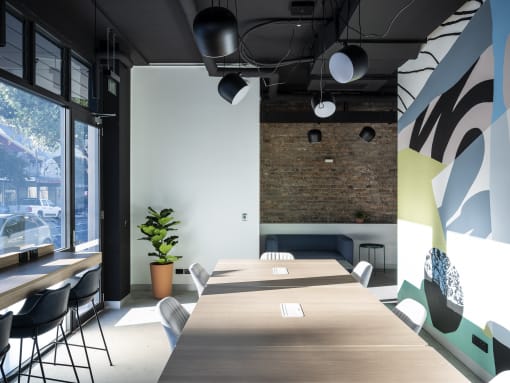 a conference room with tables and chairs and a large window