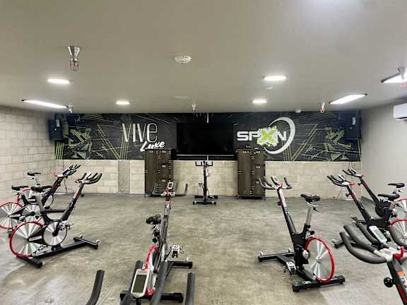 a gym with weights and cardio equipment on the floor