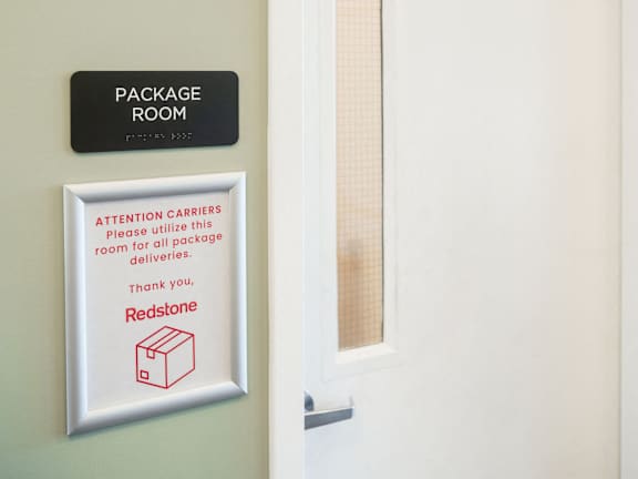 a package room door with a sign on it and a window