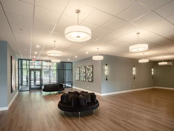 a large room with a couch and chairs in the center of it